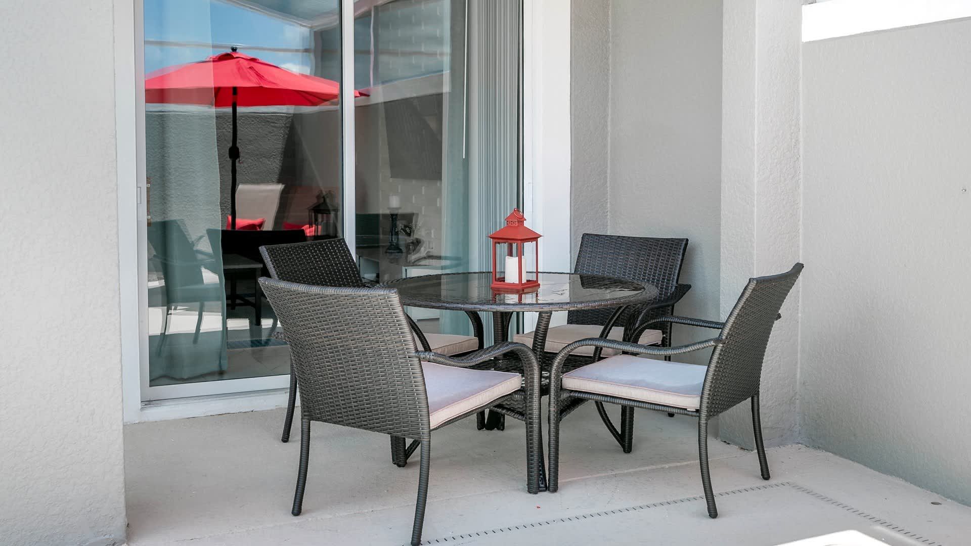 Poolside patio table, offering a perfect spot for leisurely meals and relaxation beside the private pool