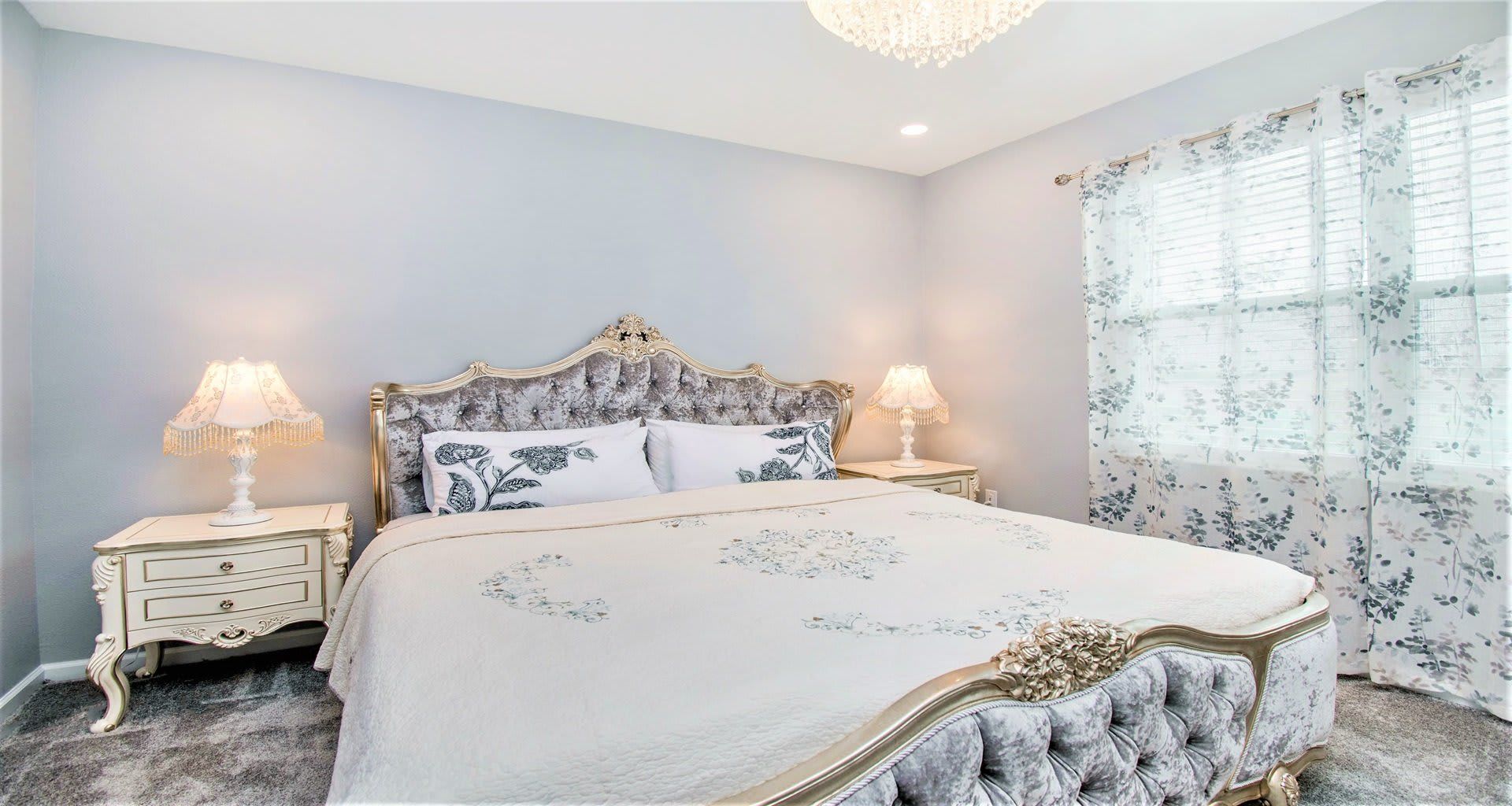 Opulent master bedroom featuring a luxuriously large king bed for a restful and indulgent retreat