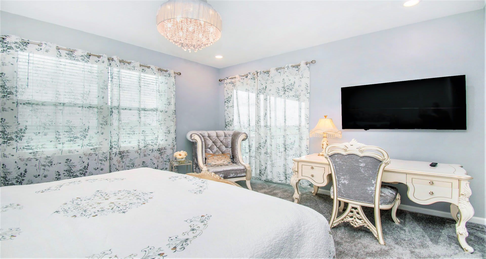 Opulent master bedroom featuring a luxuriously large king bed for a restful and indulgent retreat