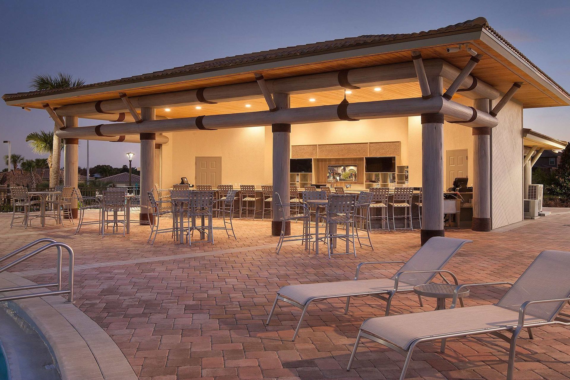 Resort Amenities - An inviting oasis, where the refreshing waters of the pool meet the laid-back charm of a poolside bar, promising a relaxing escape from the everyday hustle