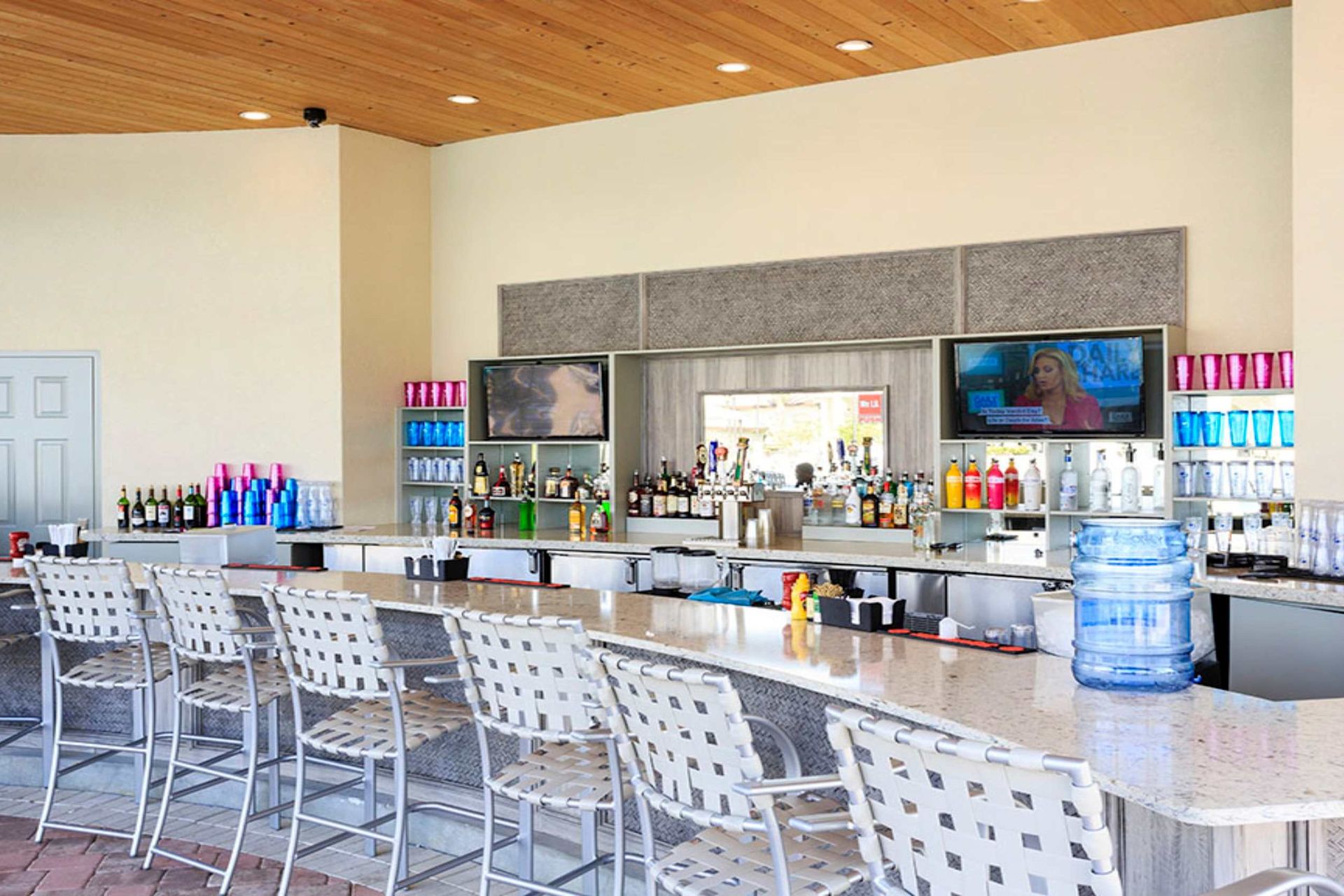 Resort Amenities - An inviting oasis, where the refreshing waters of the pool meet the laid-back charm of a poolside bar, promising a relaxing escape from the everyday hustle