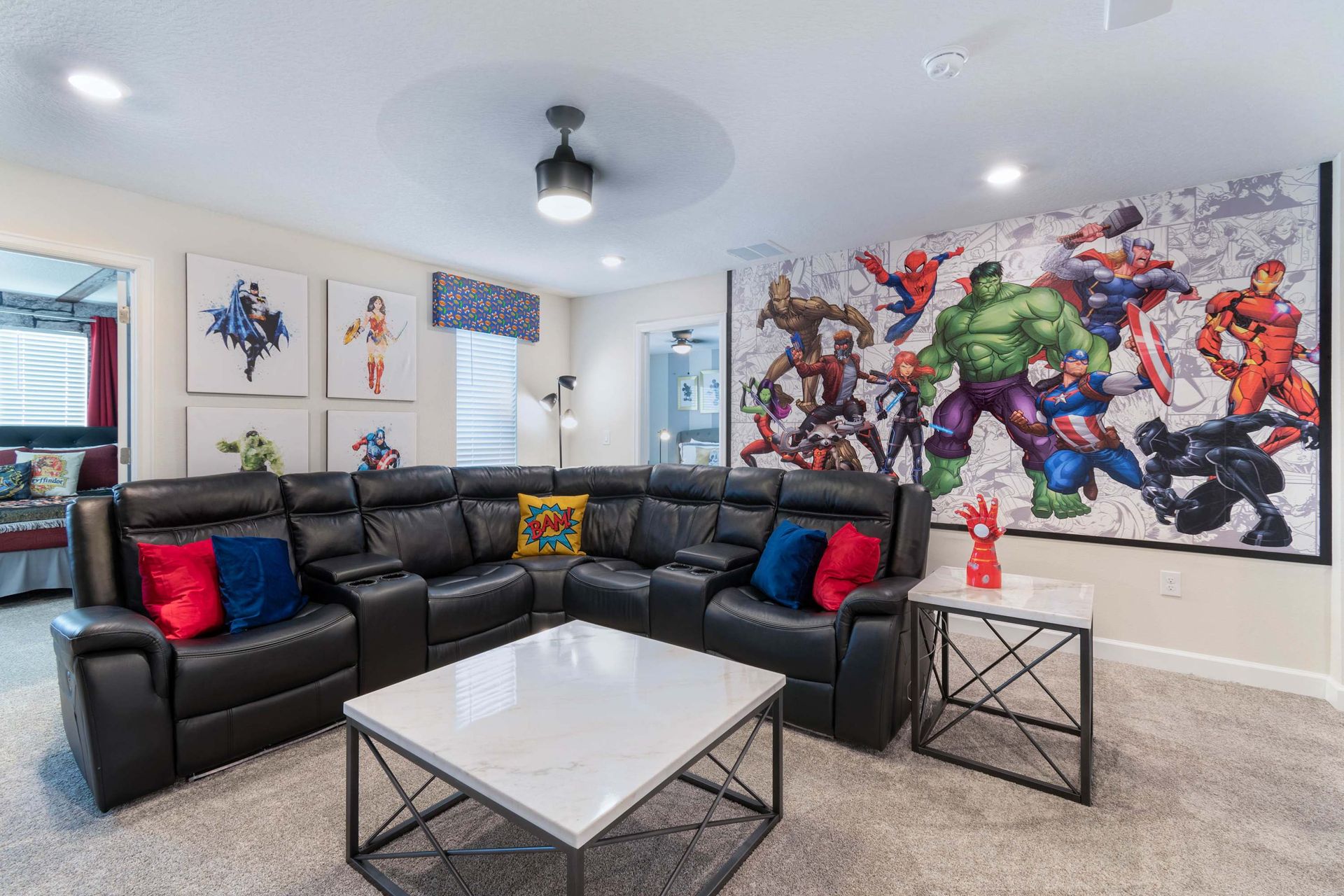 Epic superhero-themed theater room w/ recliners & bold decor!