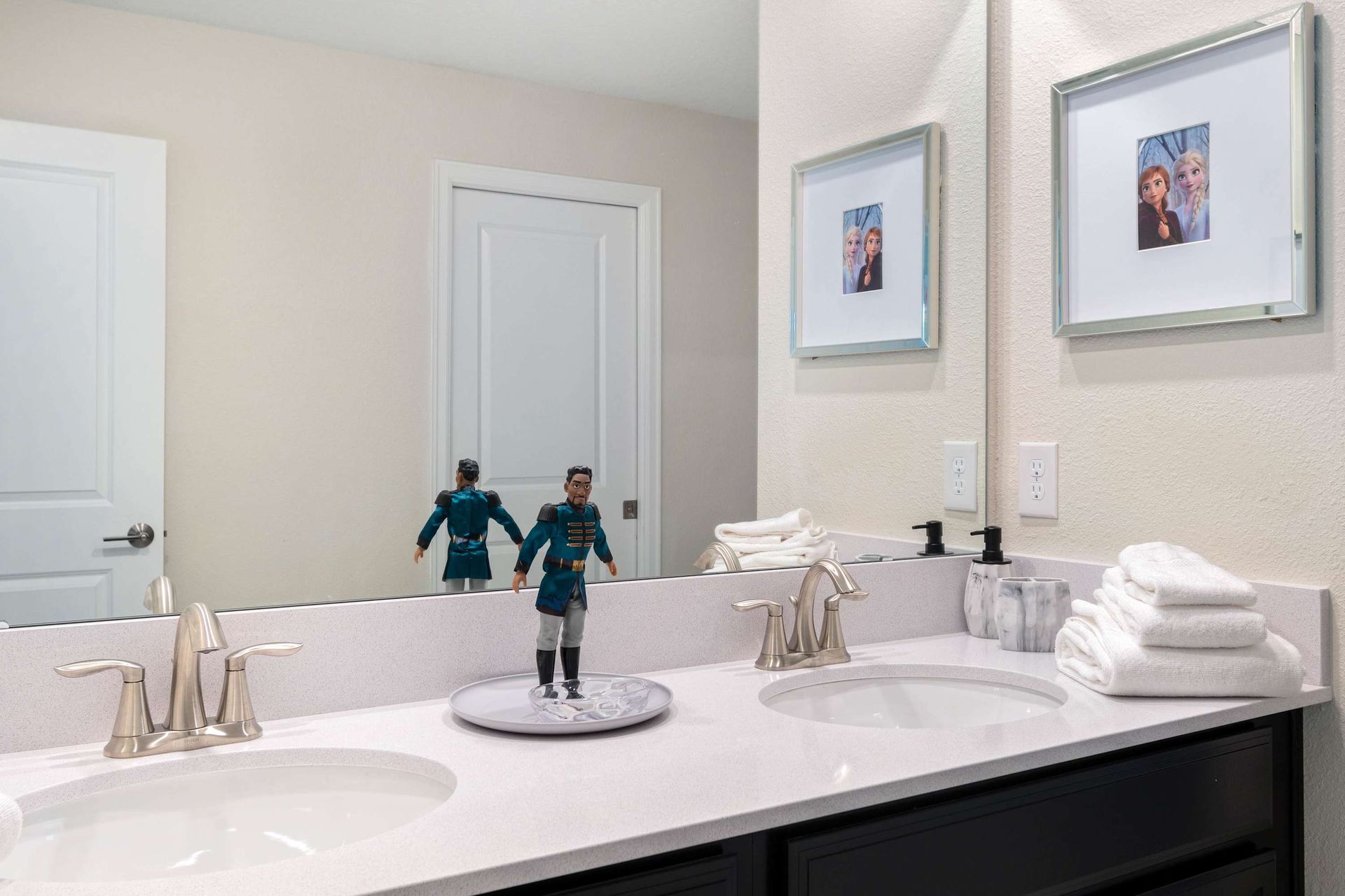 Modern bathroom w/ Frozen-inspired decor, dual sinks & cozy details!