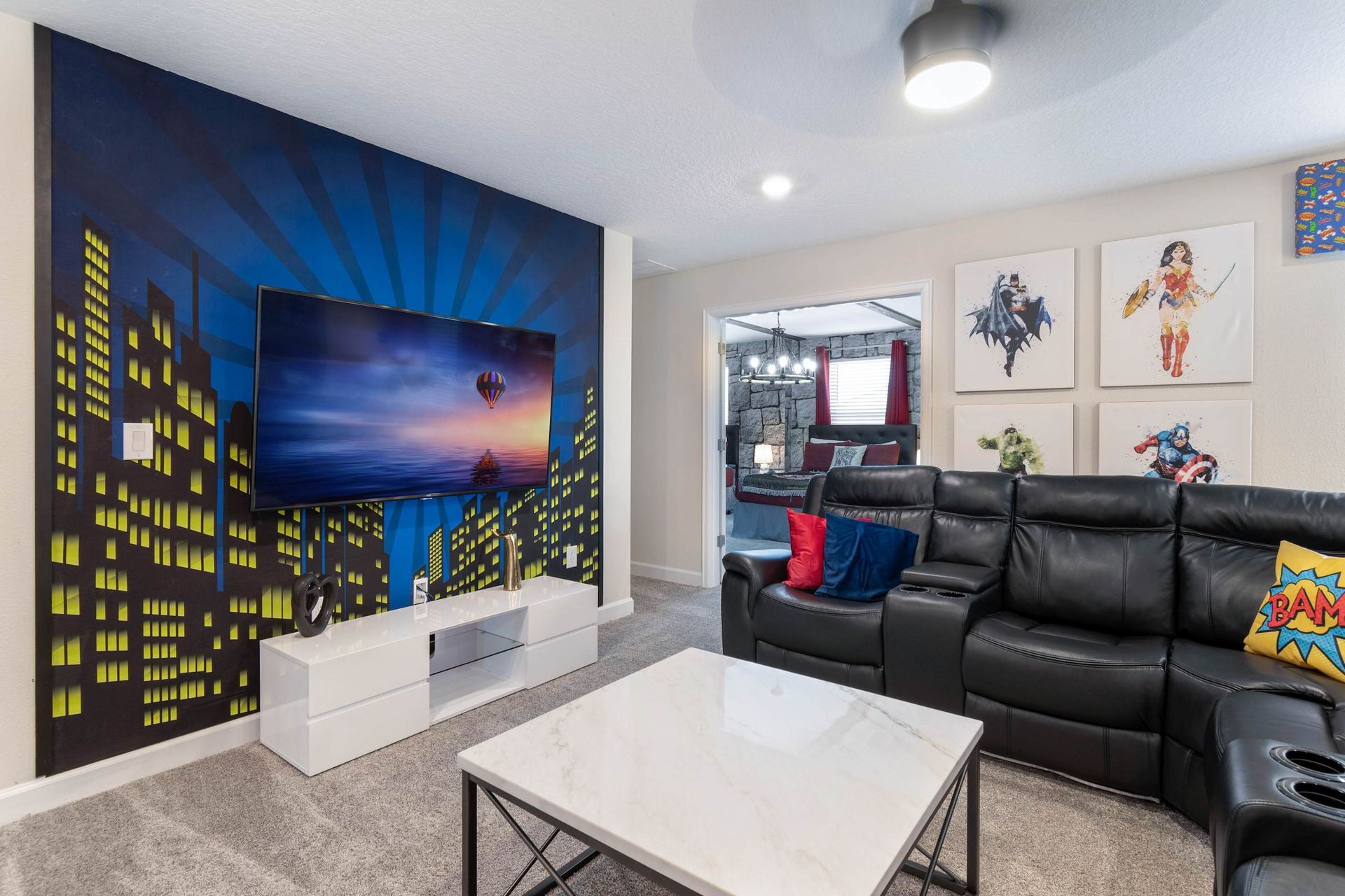 Vibrant superhero-themed lounge w/ comfy seating & cityscape TV wall!