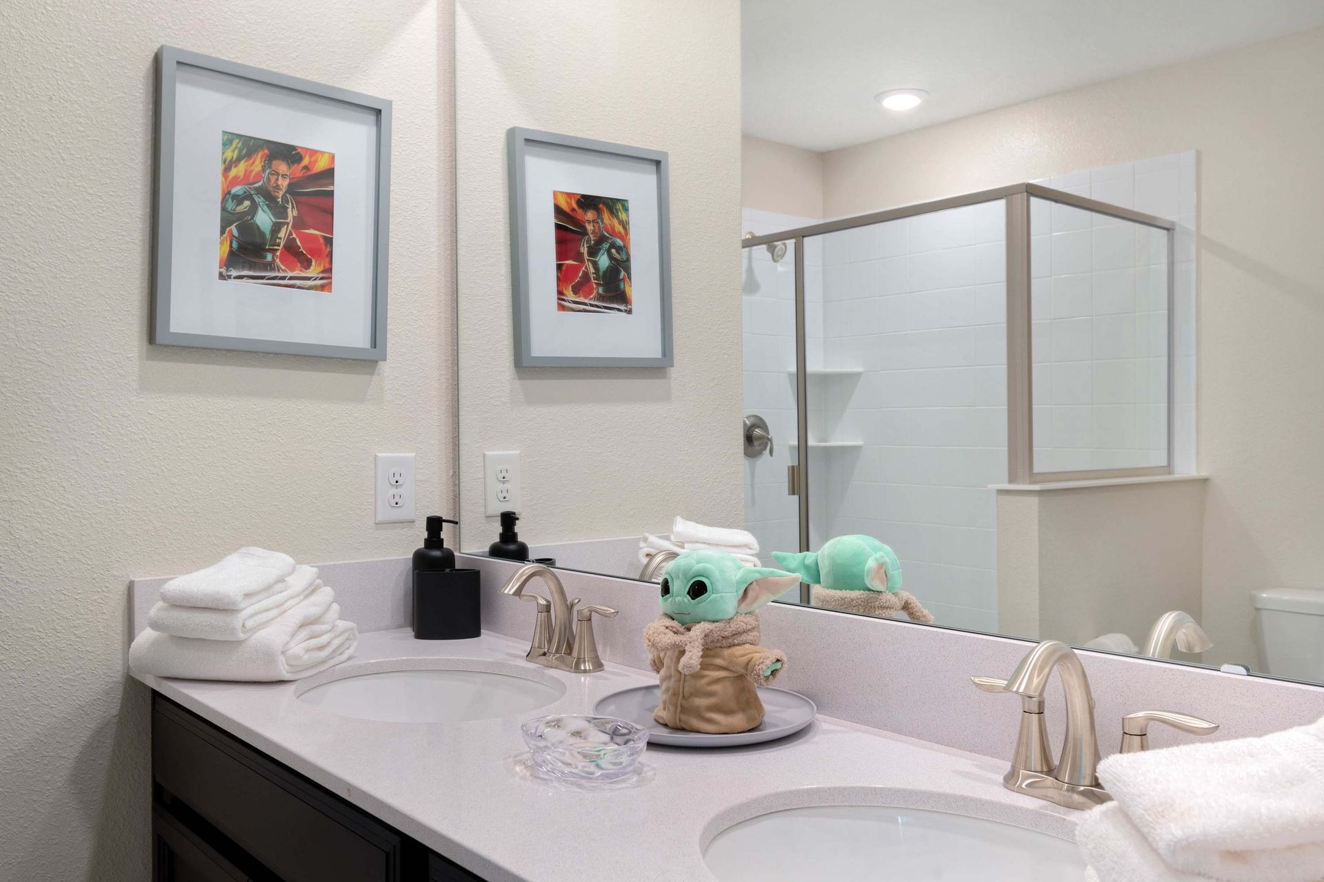 Charming bathroom w/ Grogu decor, dual sinks & modern shower