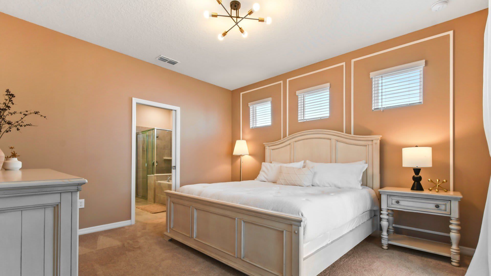 Opulent master bedroom featuring a luxuriously large king bed for a restful and indulgent retreat