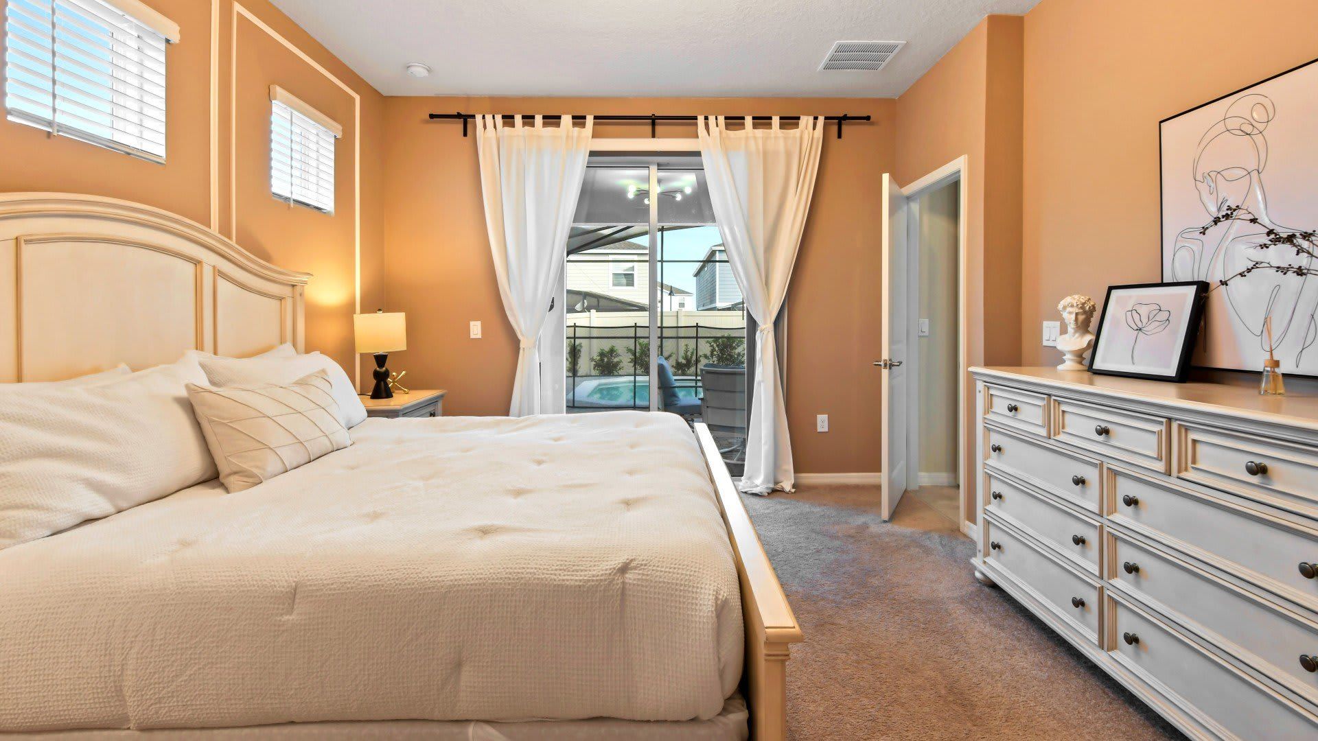 Opulent master bedroom featuring a luxuriously large king bed for a restful and indulgent retreat