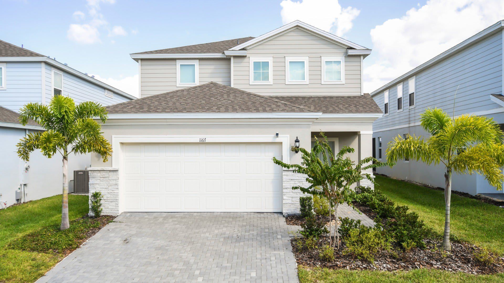 Stunning home, surrounded by lush greenery and featuring a convenient garage for a perfect blend of beauty and functionality