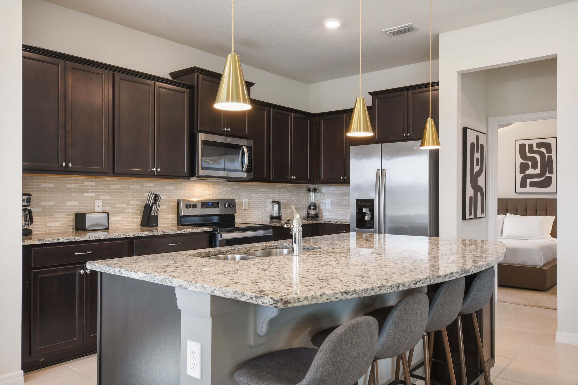 Sip on your favorite cocktails at our stylish kitchen bar, offering you a delightful way to unwind and relax.