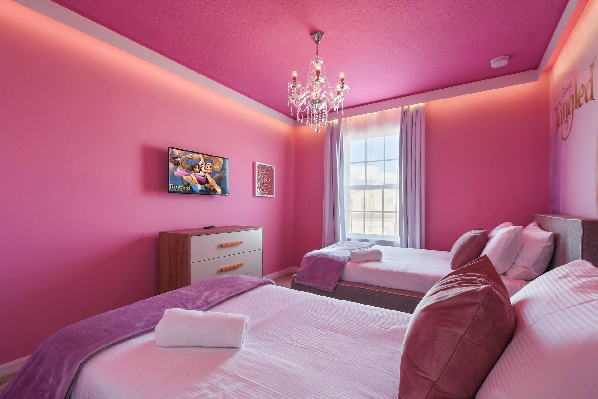 Unwind in our cozy Tangled themed room with two beds, providing you with a peaceful retreat and a restful night's sleep during your stay.