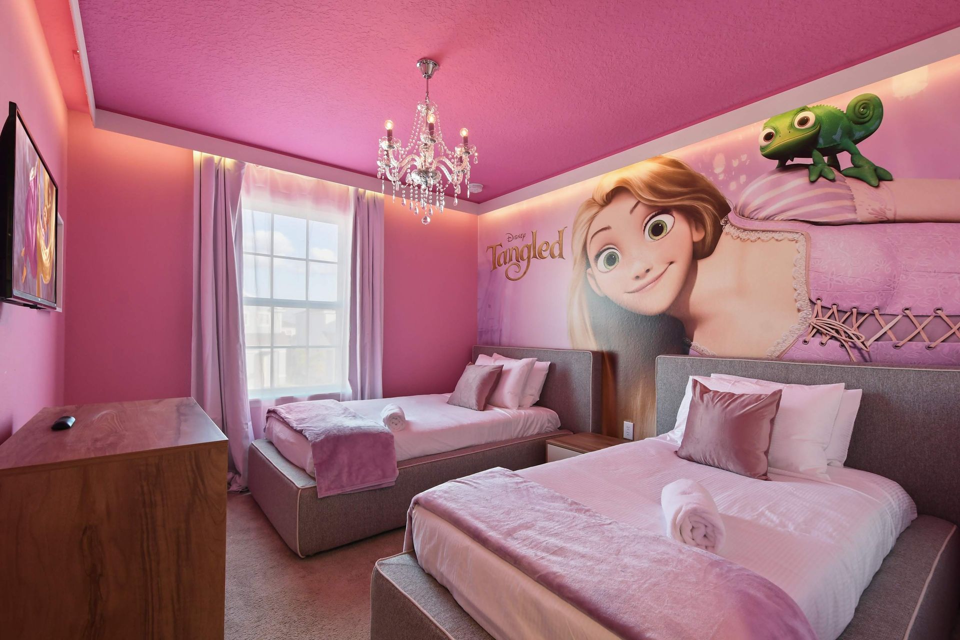 Unwind in our cozy Tangled themed room with two beds, providing you with a peaceful retreat and a restful night's sleep during your stay.