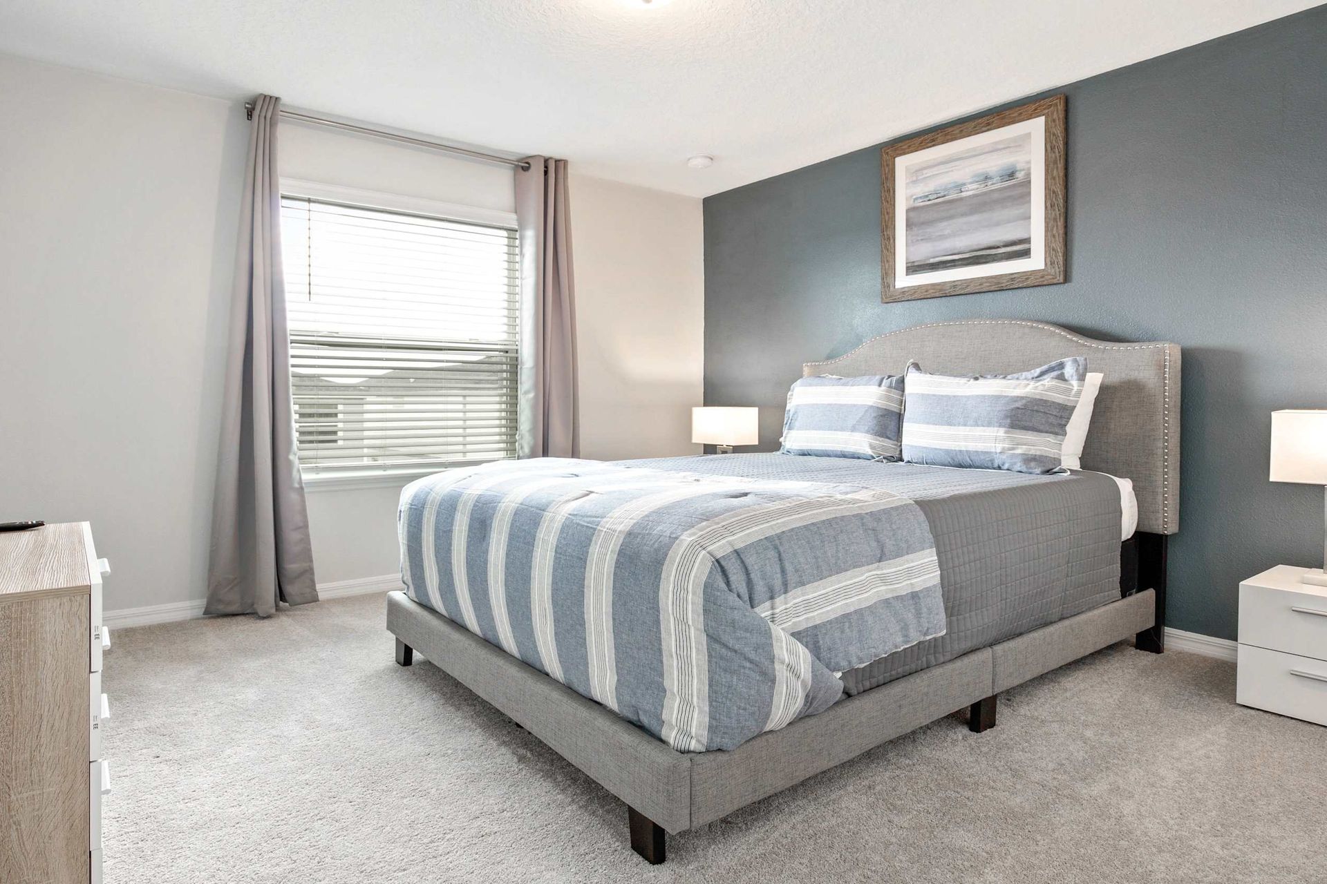 Serene queen bedroom, providing tranquility with the added comfort of a TV for peaceful relaxation