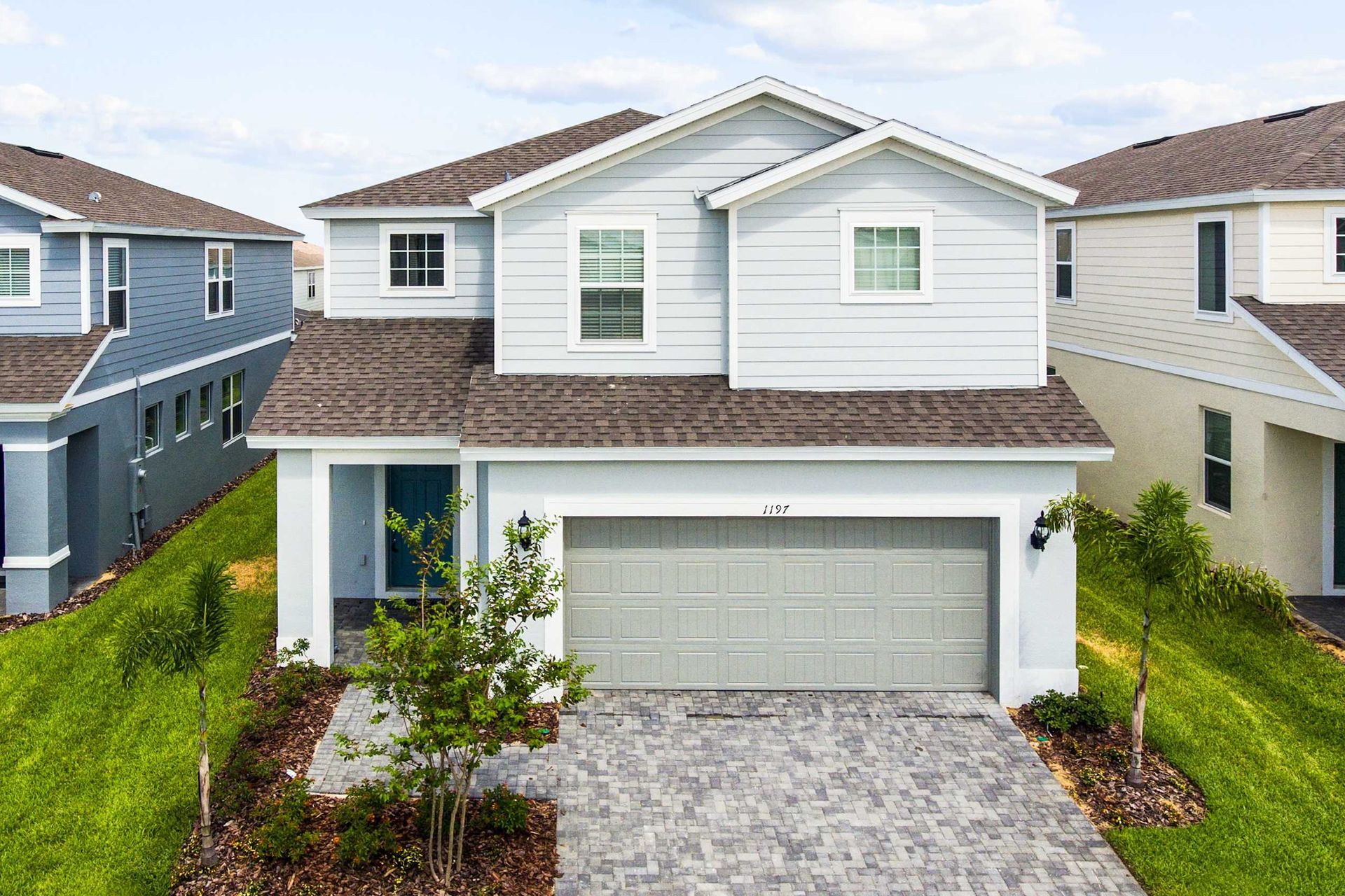 Contemporary residence with a garage, surrounded by lush greenery for a perfect blend of style and nature
