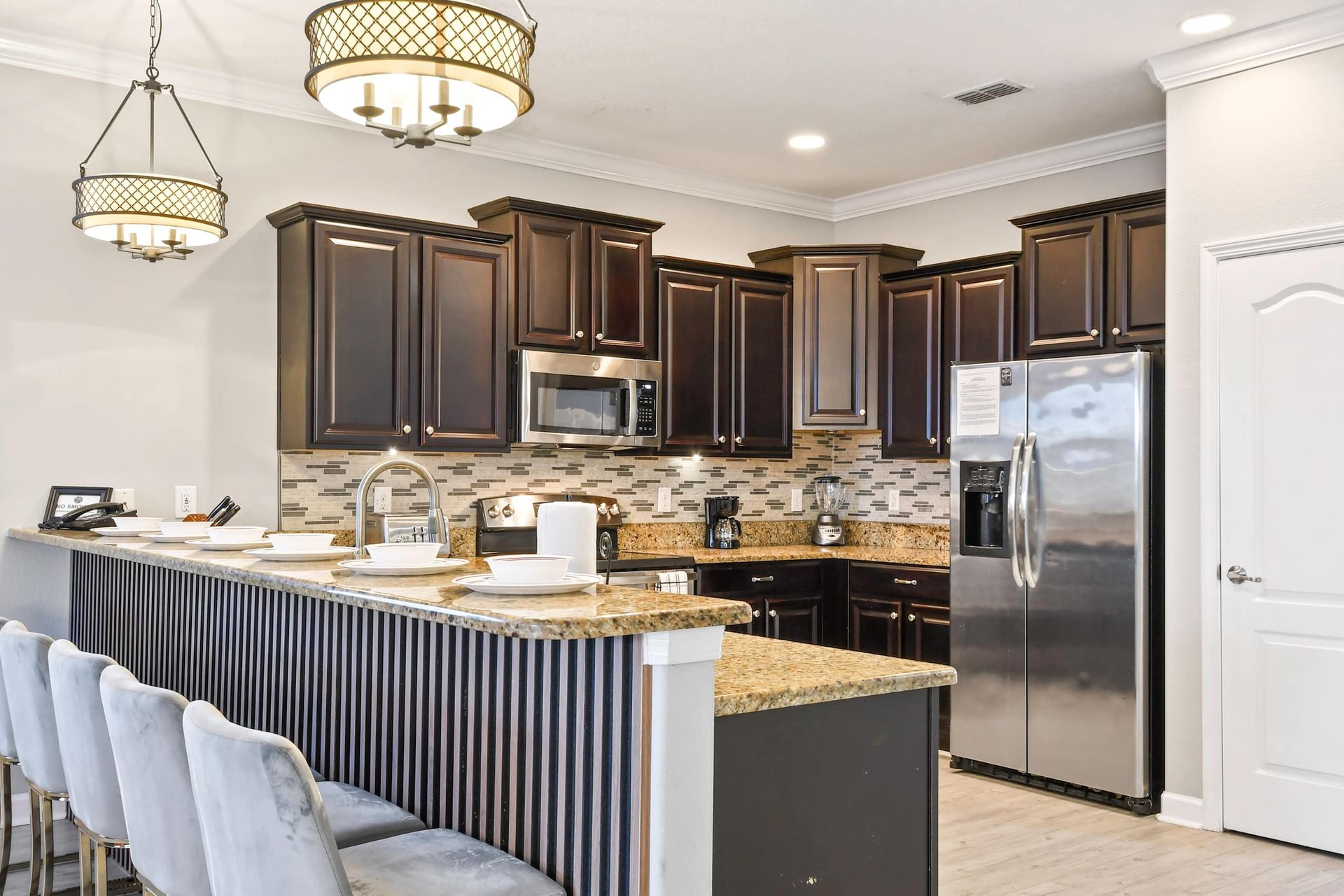 Compact kitchen, featuring a charming mini breakfast bar for cozy morning gatherings