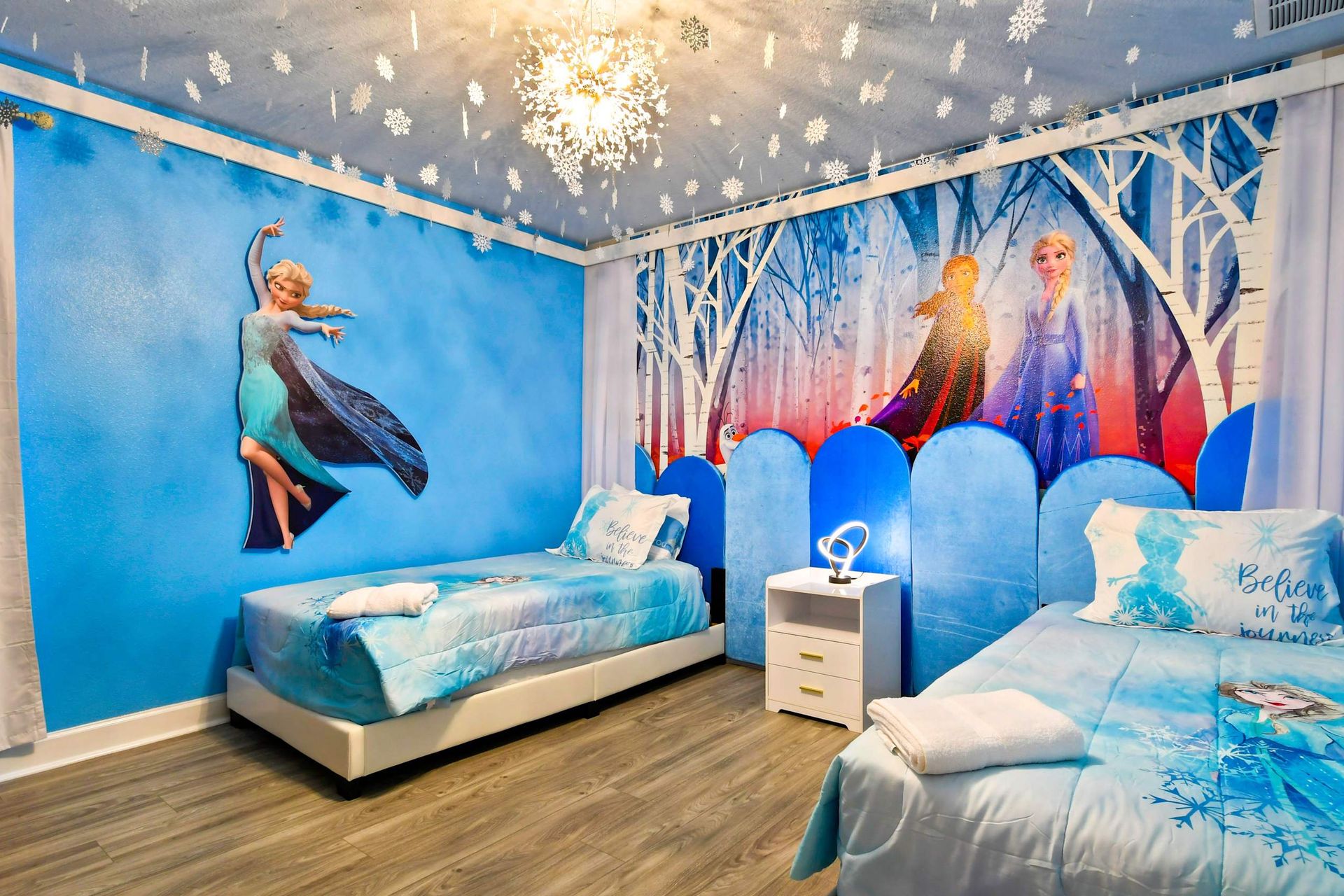 Charming Frozen-themed room with two twin beds, providing a whimsical and enchanting space for young fans