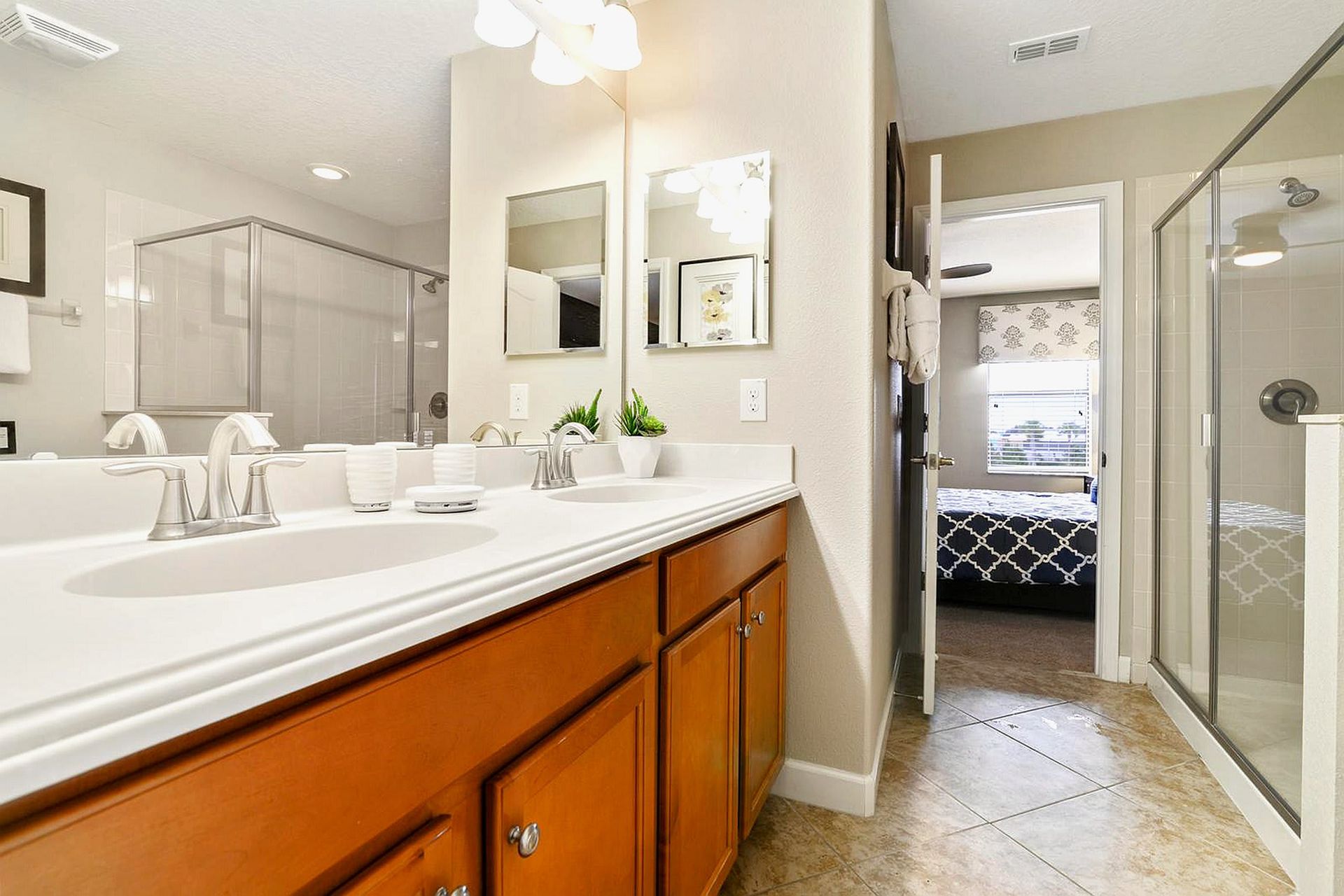 Modern bathroom with double vanity, spacious shower, and bright decor for a refreshing atmosphere.