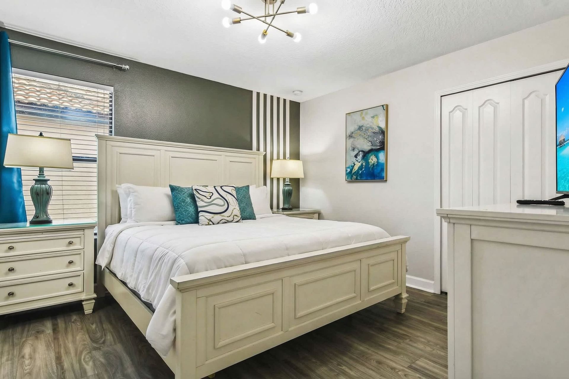 Serene queen bedroom, providing tranquility with the added comfort of a TV for peaceful relaxation
