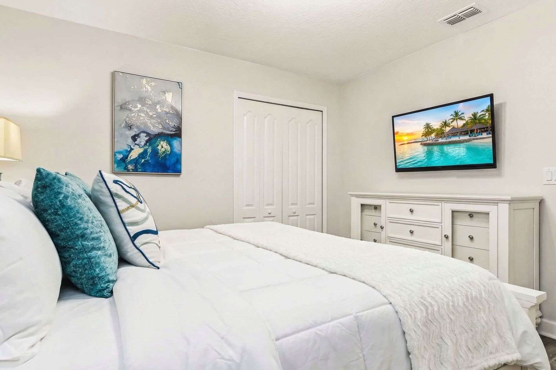Serene queen bedroom, providing tranquility with the added comfort of a TV for peaceful relaxation