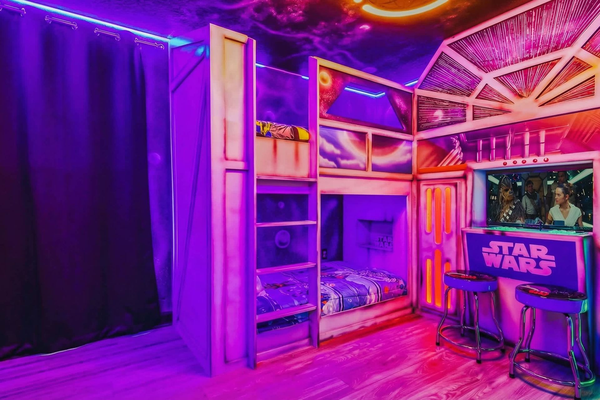 Star Wars-themed bedroom with vibrant neon lighting, custom bunk beds, and a bar area featuring iconic characters.