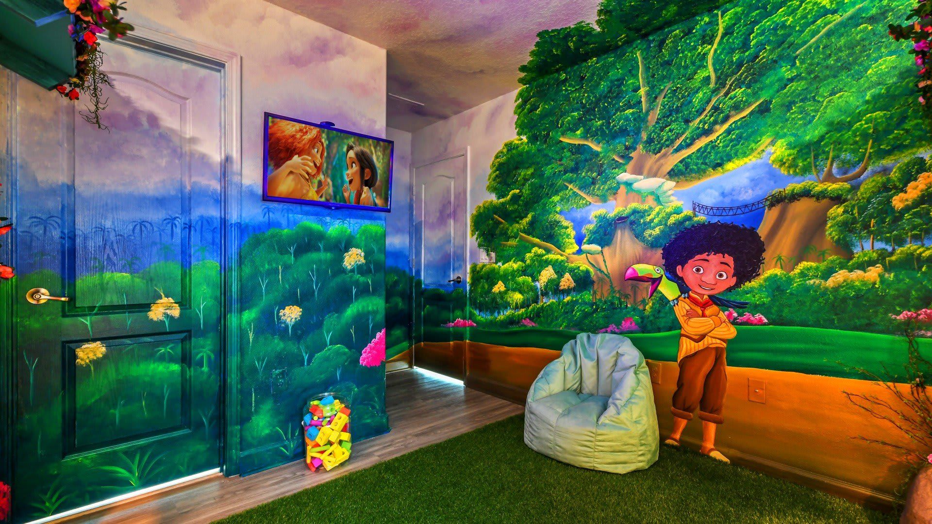 Whimsical jungle-themed kids' room with vibrant murals, a cozy bean bag, and a TV showing animated movies.