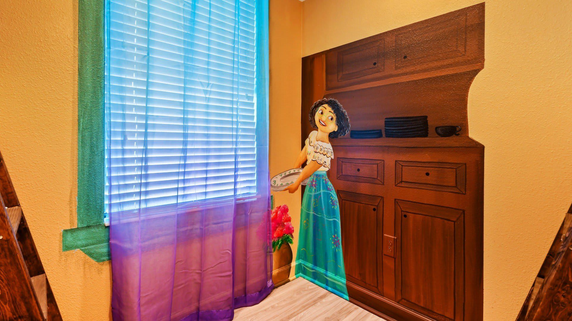 Whimsical room corner with a mural of a cheerful girl holding a plate, colorful curtains, and a sunny window.