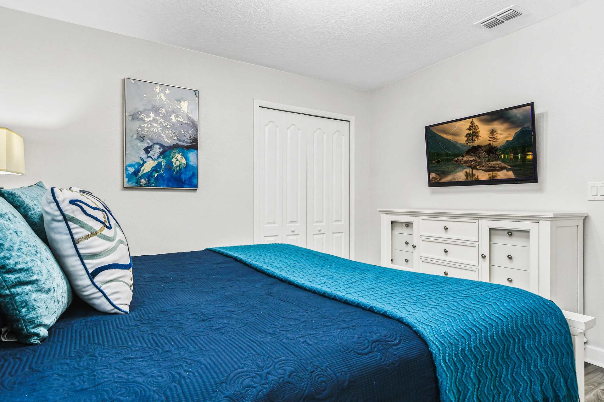 Serene queen bedroom, providing tranquility with the added comfort of a TV for peaceful relaxation
