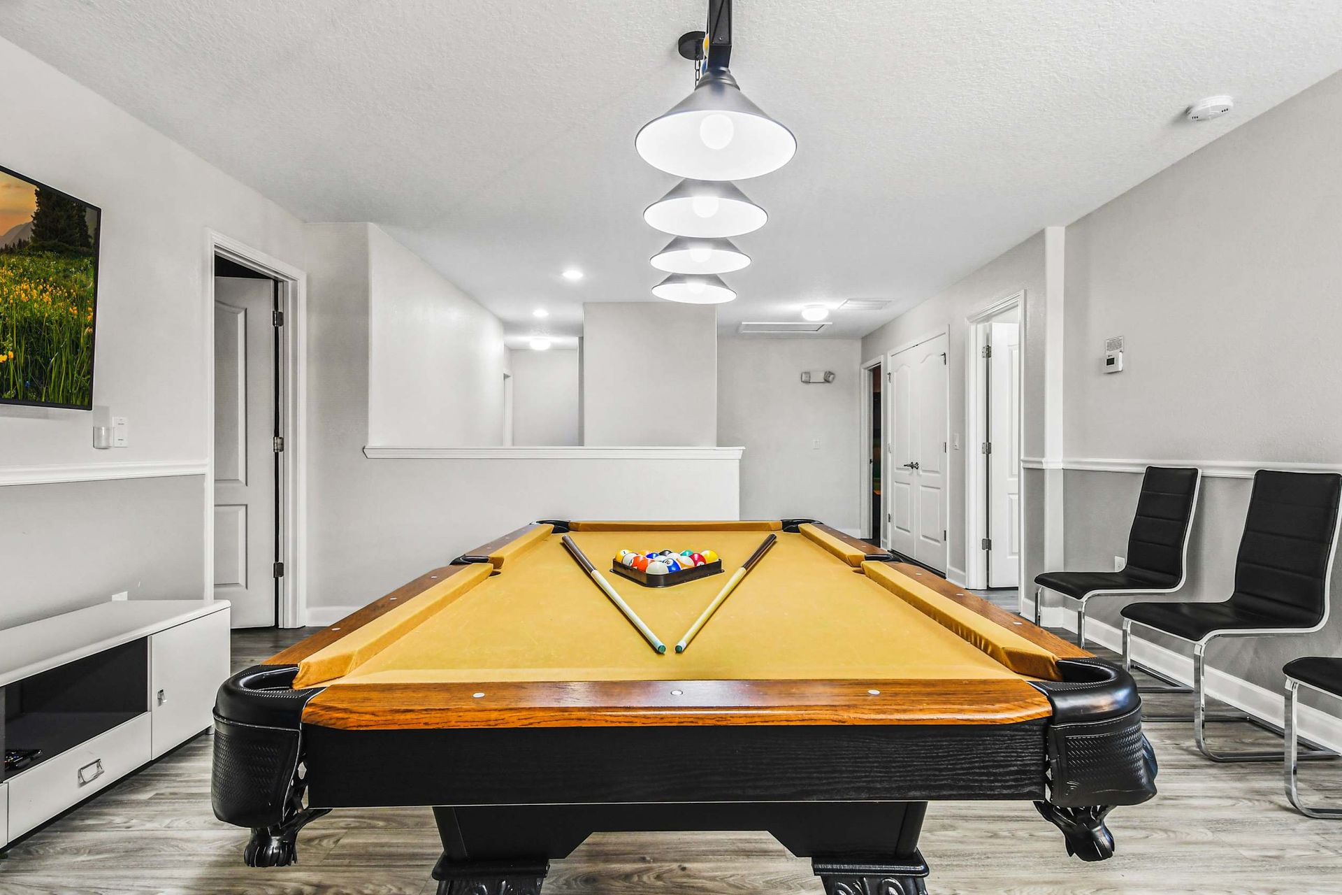 House with a pool table, providing a recreational and entertaining space for family and friends