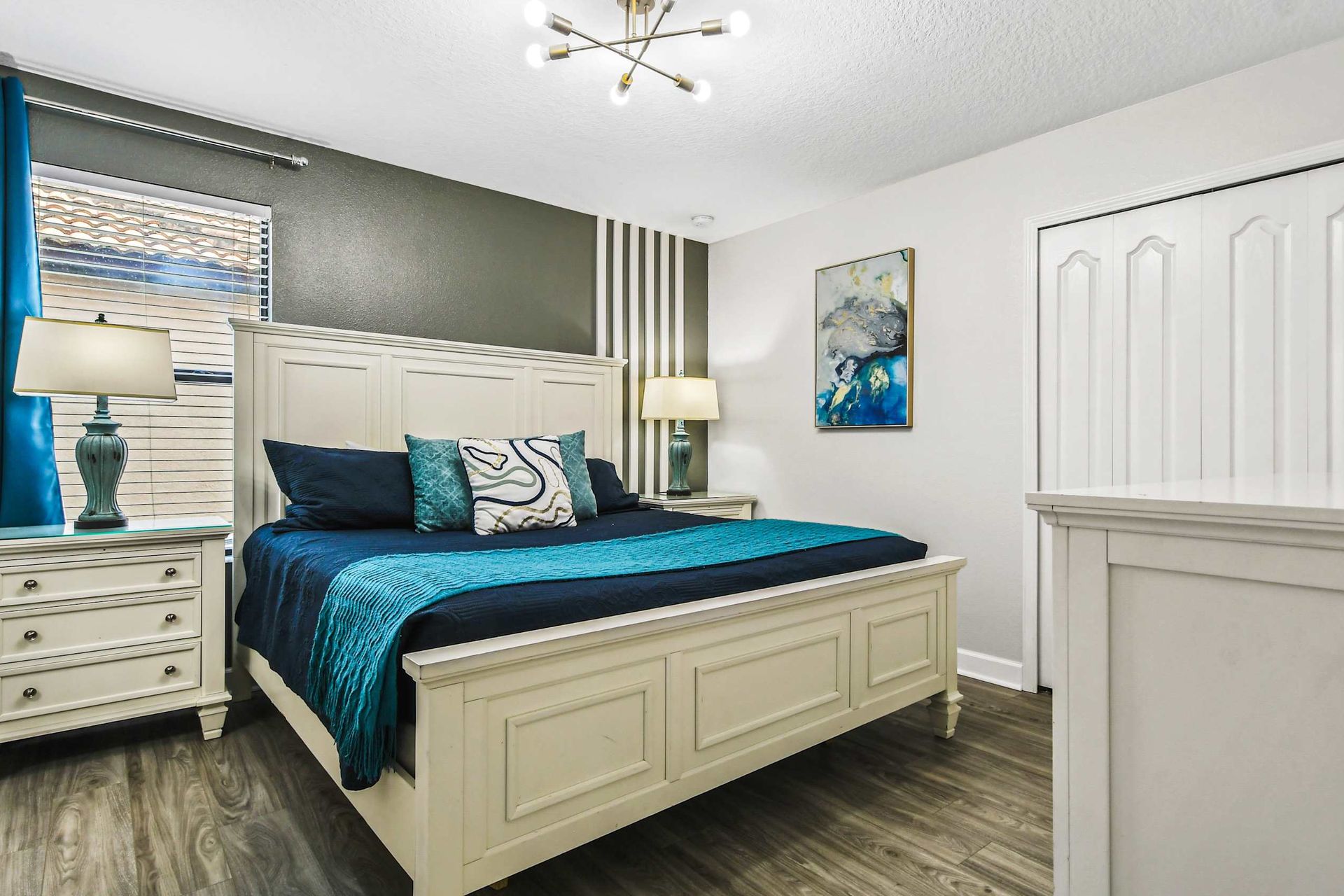 Serene queen bedroom, providing tranquility with the added comfort of a TV for peaceful relaxation