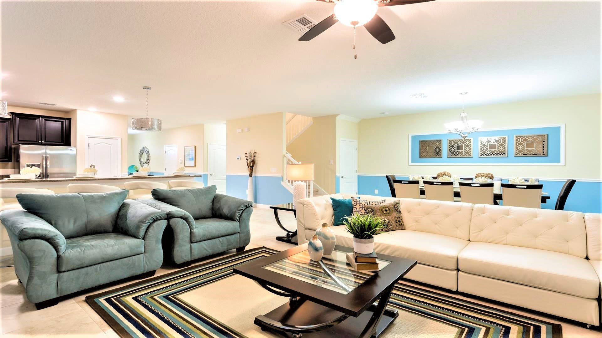Spacious, modern living area with cozy seating, elegant decor, and open dining space.