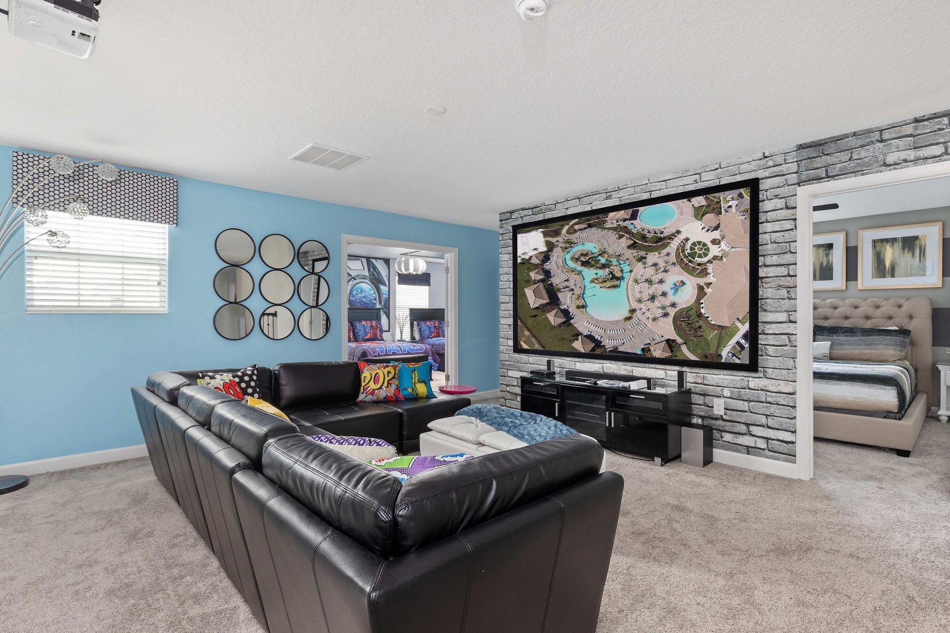 Spacious lounge with huge projector, cozy seating, and fun decor!