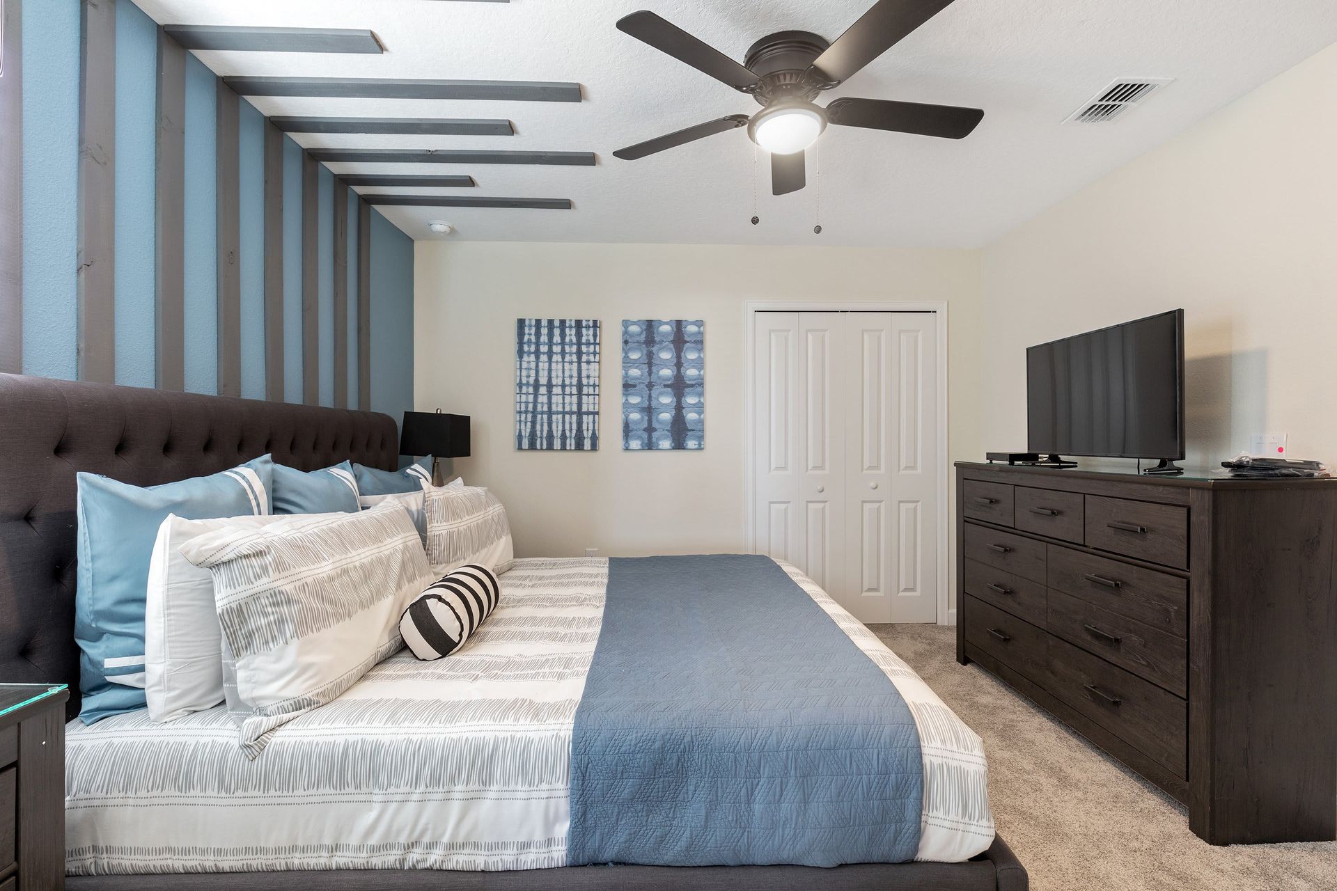 Cozy bedroom with unique accent wall, king bed, and modern touches!