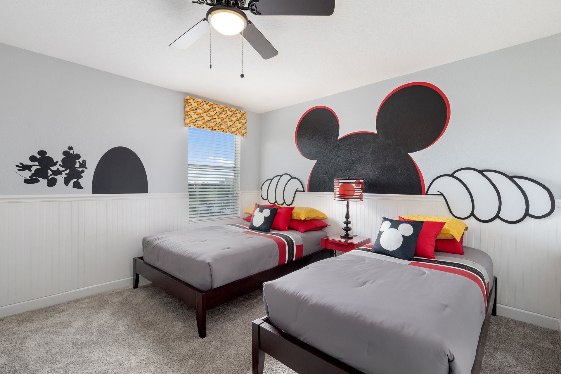 Whimsical Mickey Mouse-themed room with twin beds and fun decor!