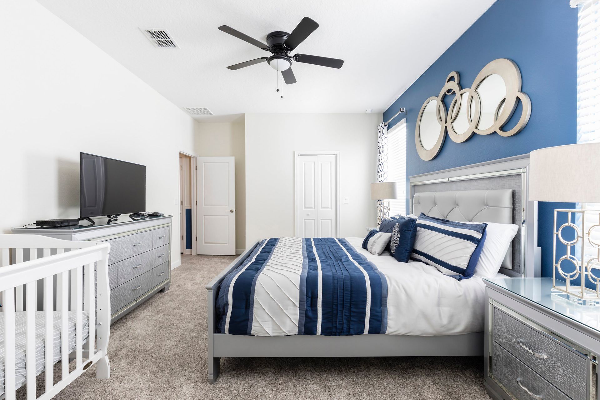 Spacious master bedroom with king bed, modern decor, and crib!