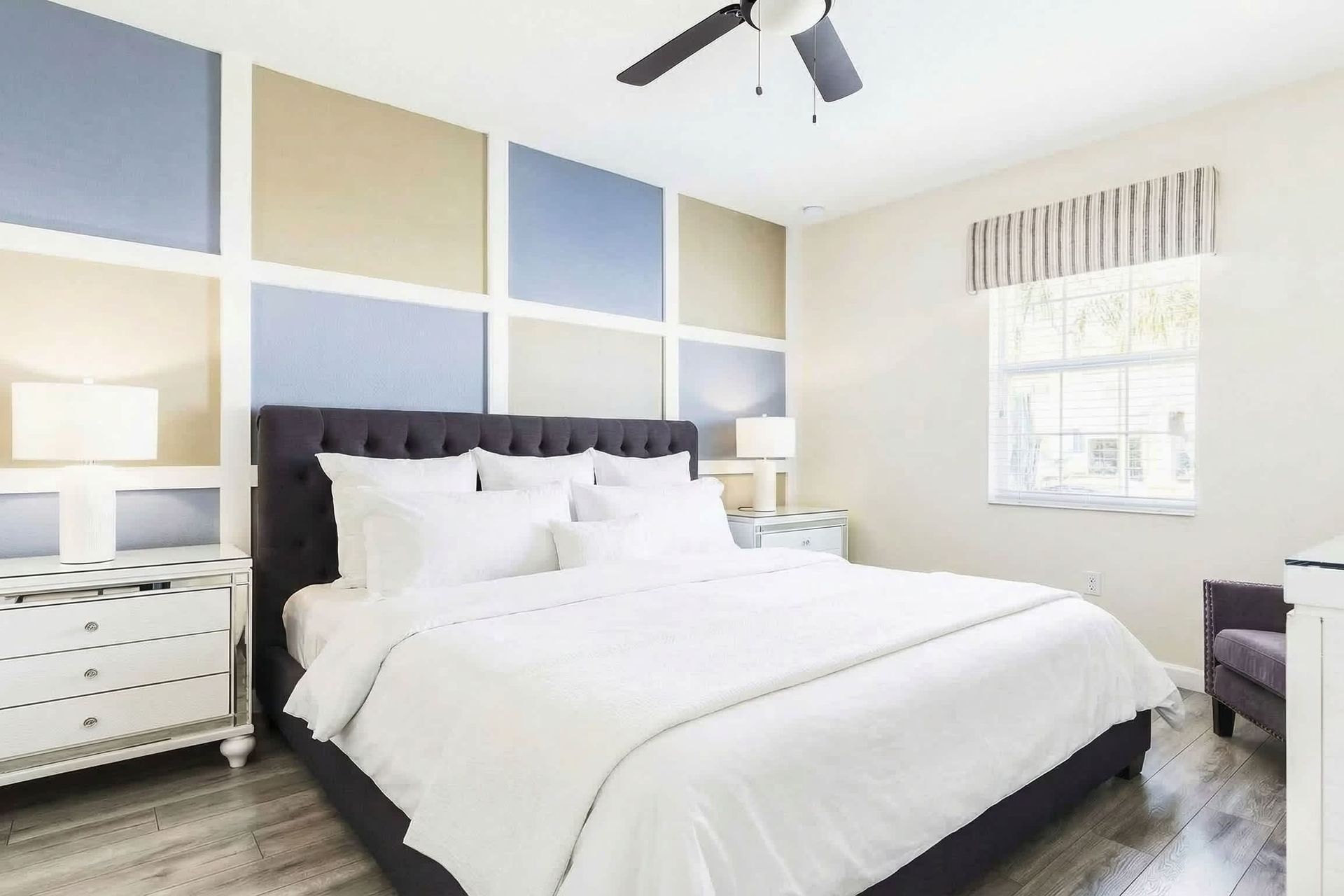 Calm and cozy bedroom with a plush bed, stylish accent wall, and plenty of natural light.