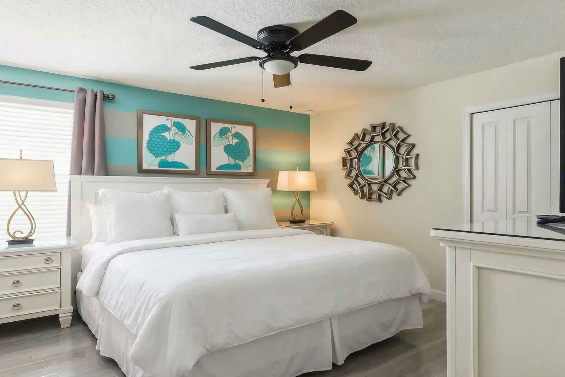 Neat and tidy queen bedroom equipped with a TV