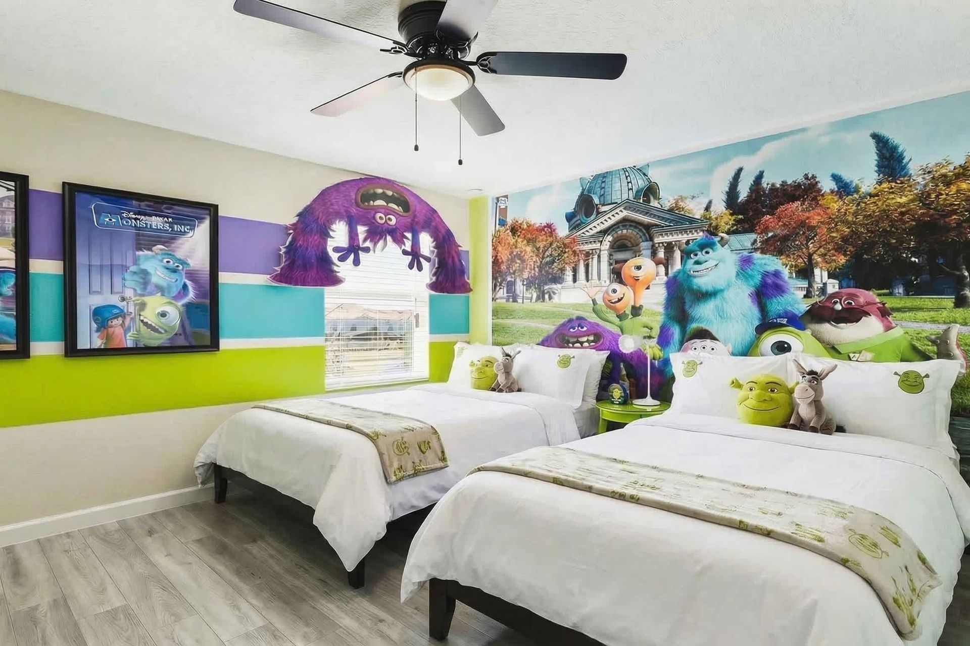 Fun Monsters-themed bedroom with twin beds, colorful decor, and character murals—perfect for kids!