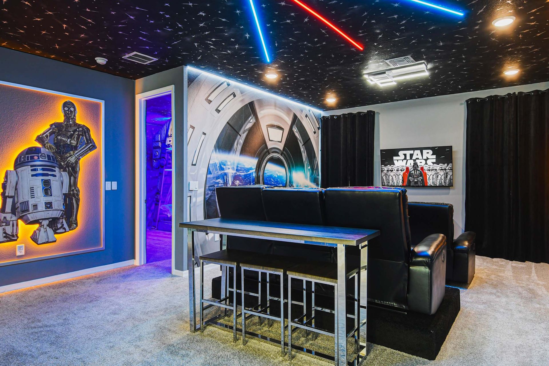 Immersive home theater with sci-fi decor, starry ceiling, and themed lighting