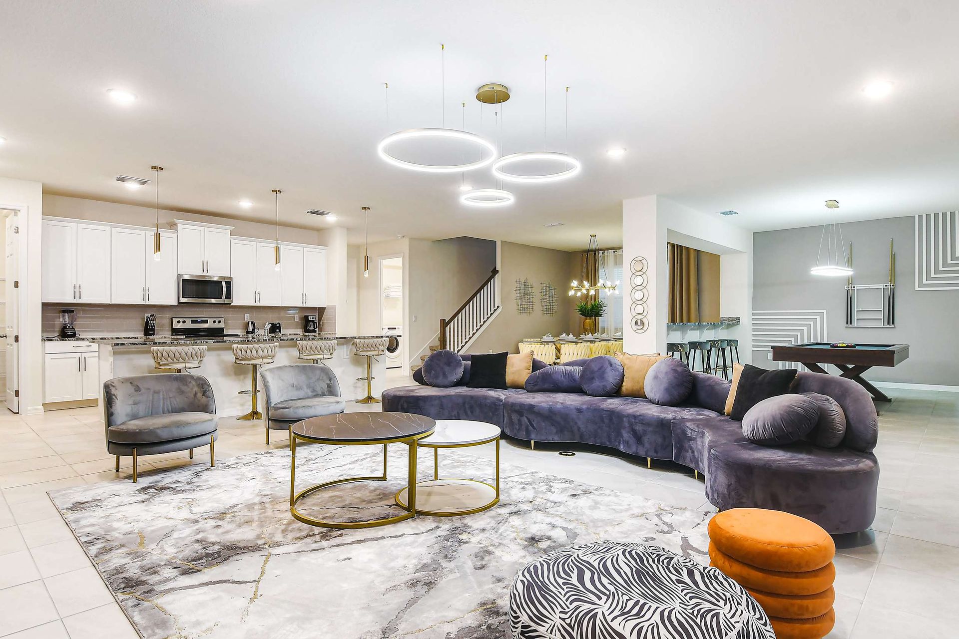 Spacious modern retreat with open kitchen, elegant lounge, and pool table.