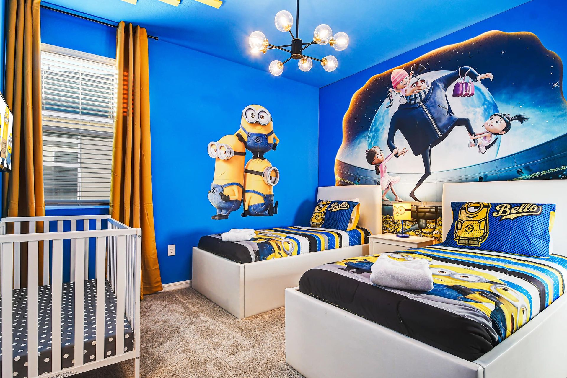 Playful themed kids' room with twin beds, vibrant decor, and a crib.