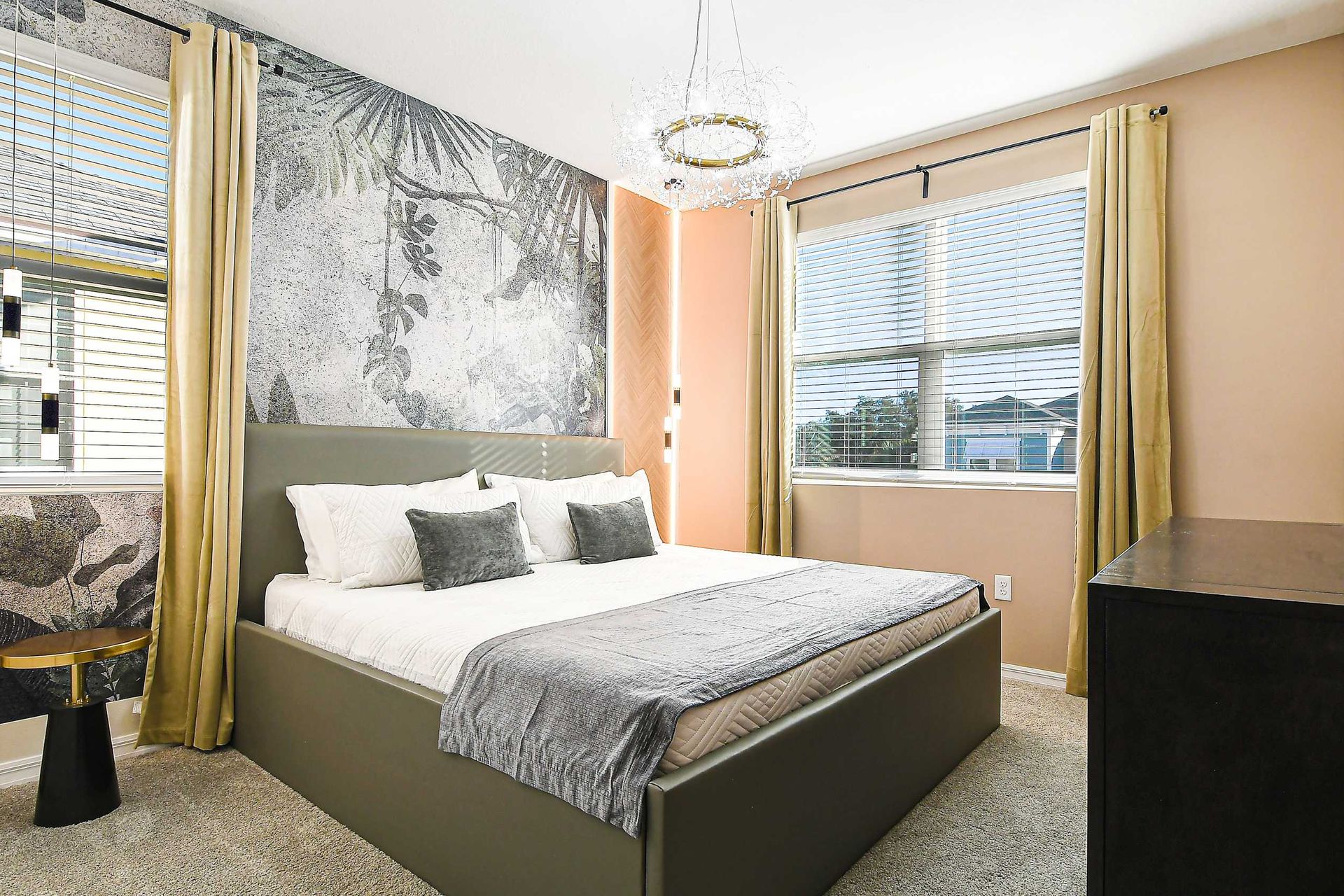 Stylish bedroom with modern decor, plush bedding, and natural light.