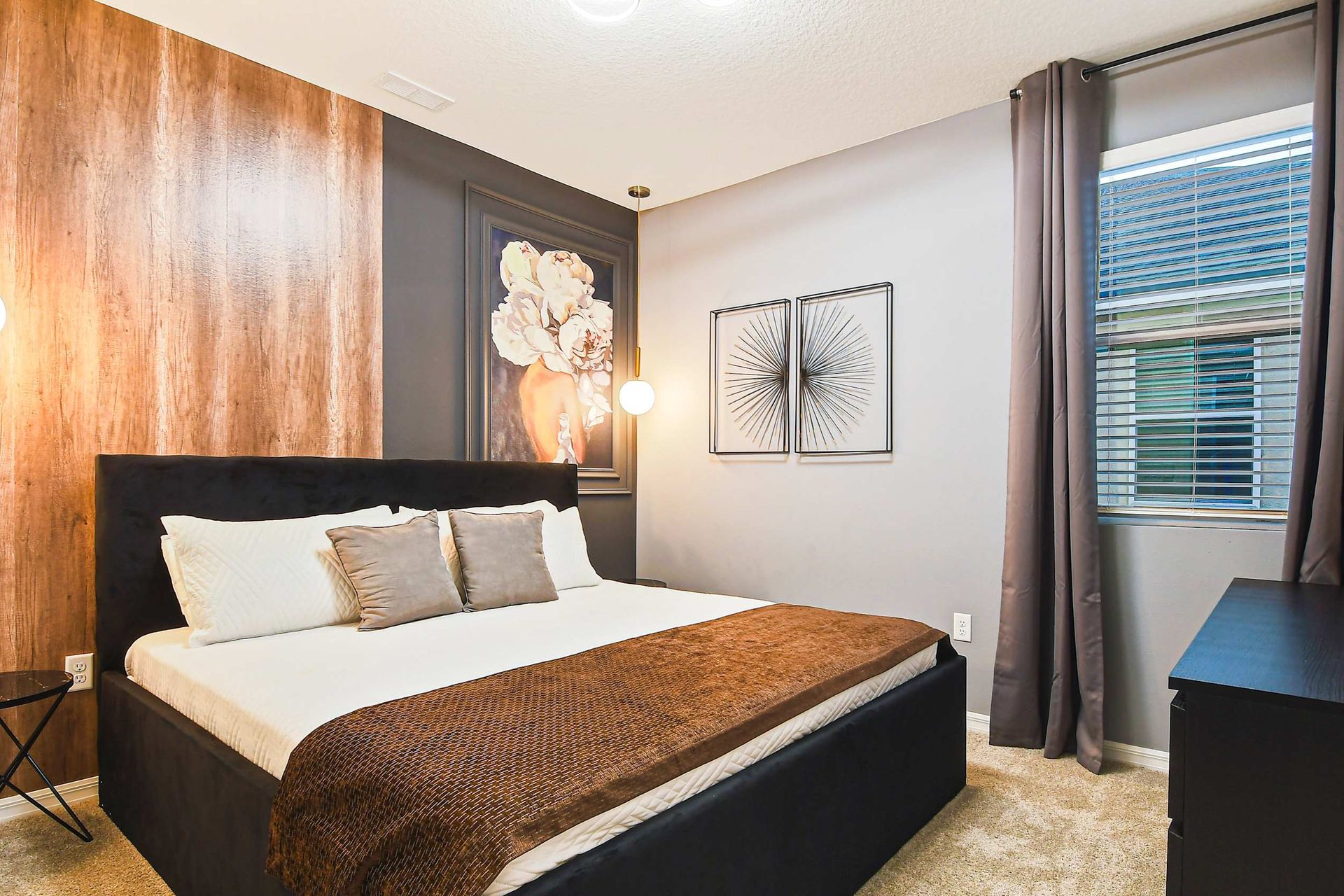 Cozy bedroom with chic accent wall, modern decor, and warm lighting.