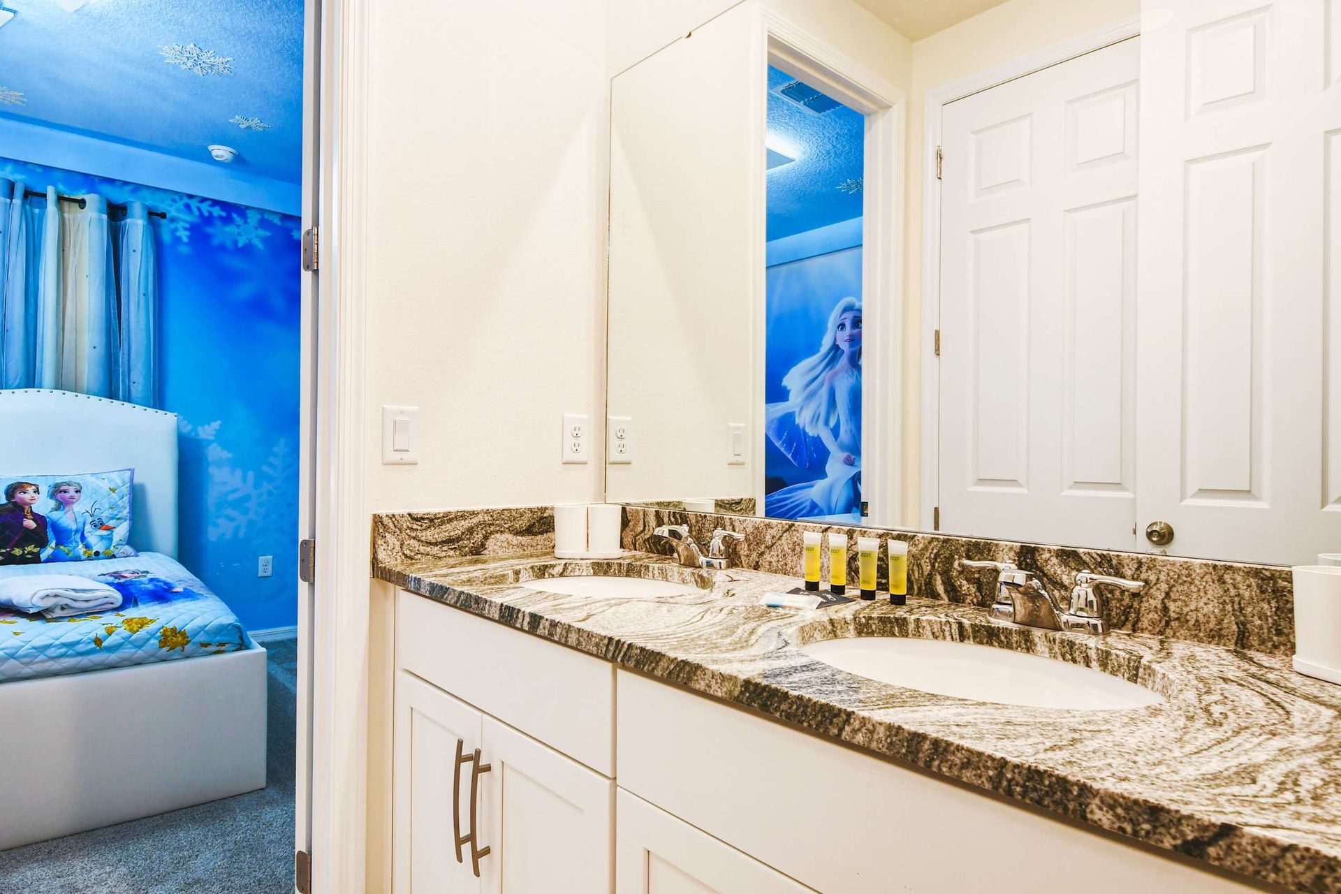 Charming themed kids' room with adjoining bathroom and double granite sinks.