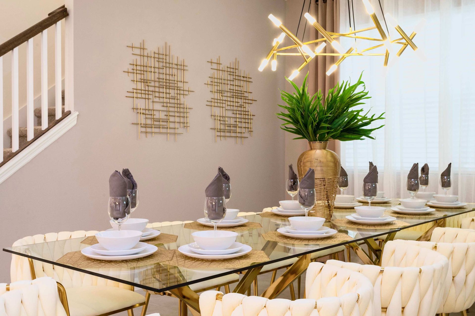 Elegant dining area with a glass table, modern decor, and stylish lighting.