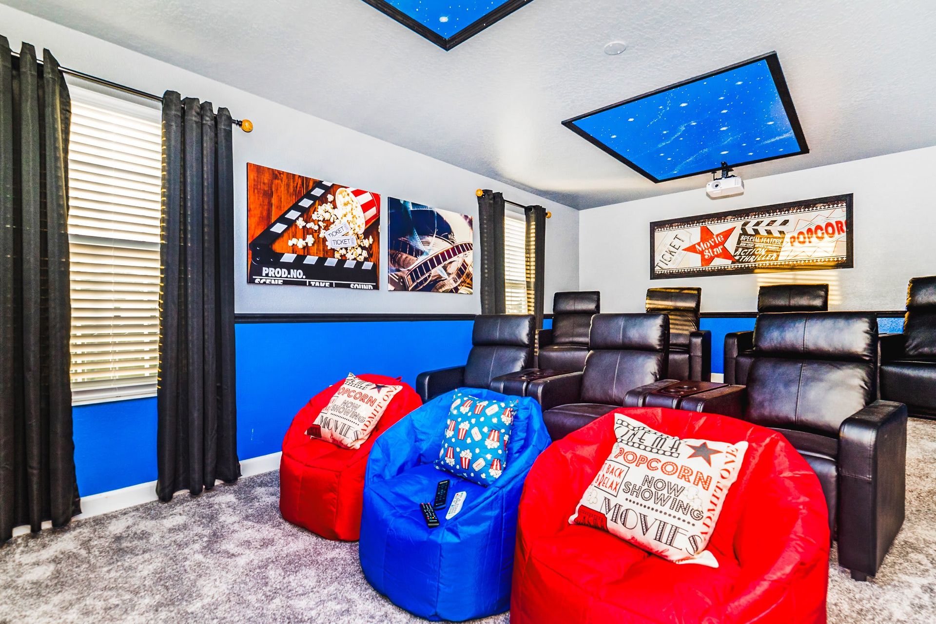 Cozy home theater with recliners, bean bags, starry ceiling, and movie decor.
