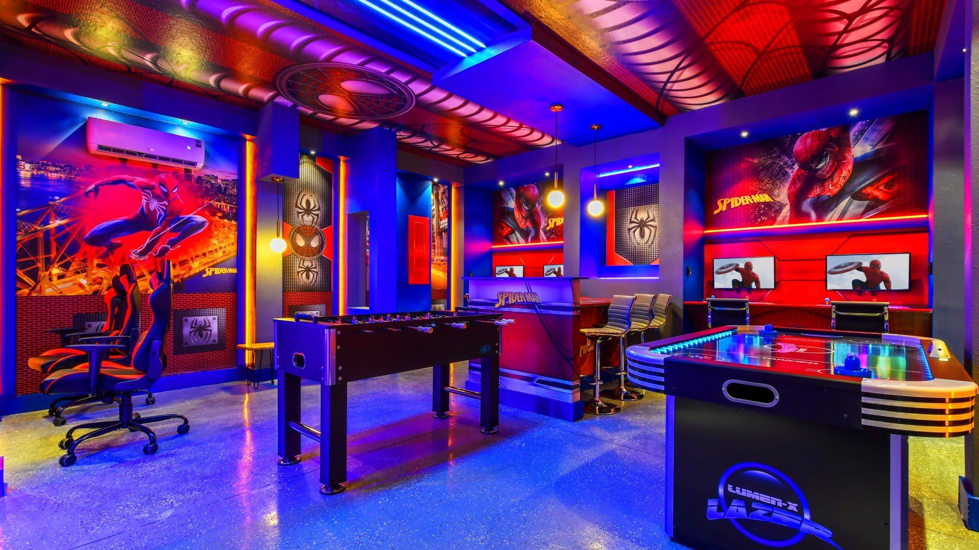 Vibrant superhero-themed game room with arcade games, foosball, and bold decor.