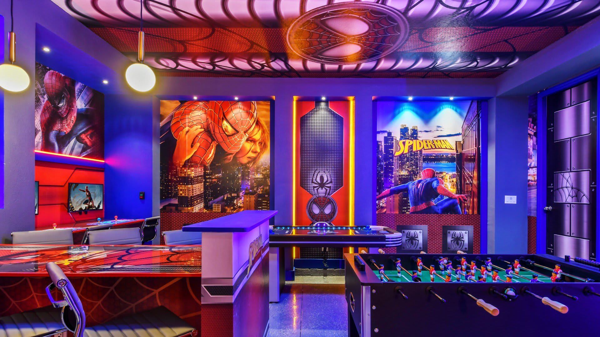 Action-packed superhero game room with arcade games, foosball, and bold lighting.