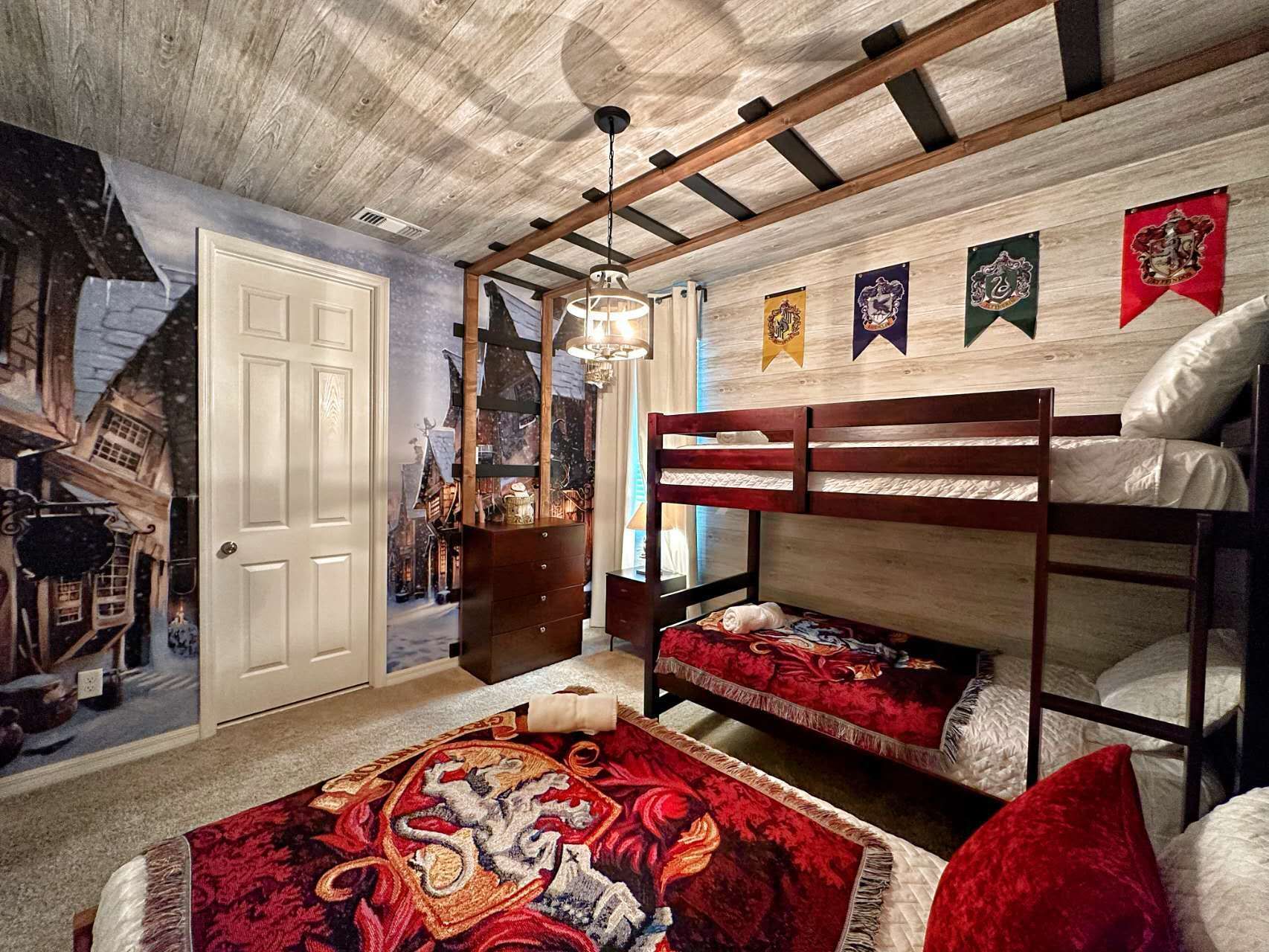 Magical themed bedroom with cozy bunk beds, house banners, and enchanting decor.
