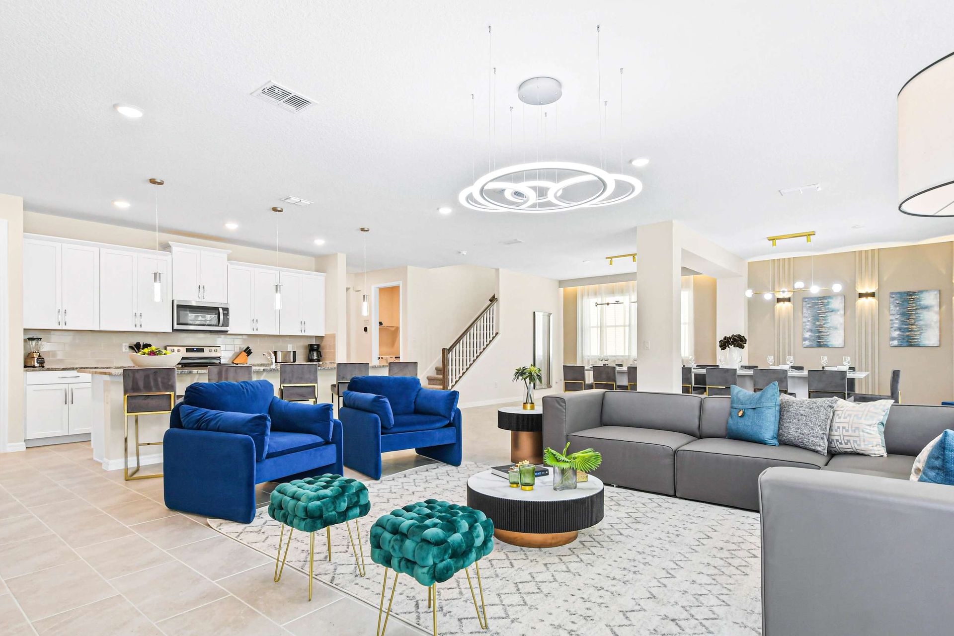 Modern open-concept living area with cozy seating, stylish kitchen, and elegant lighting.