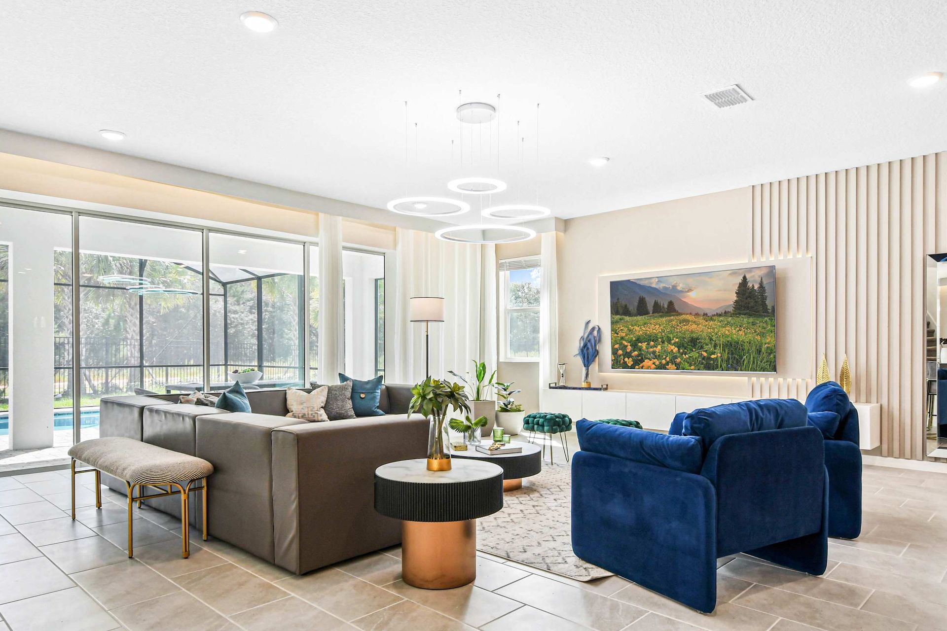 Bright living room with pool view, modern decor, and comfortable seating.