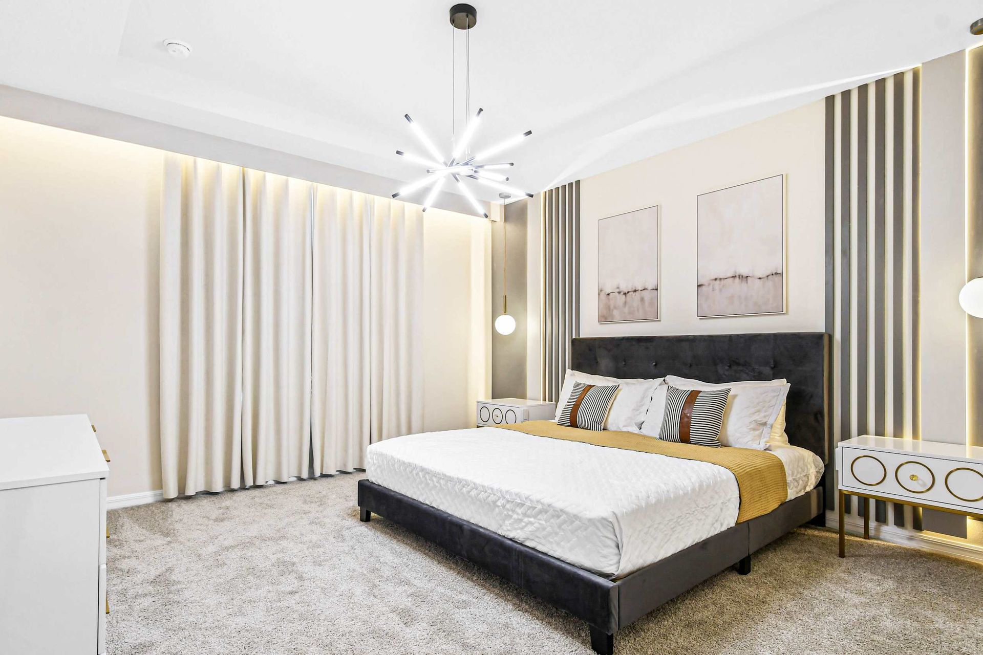 Modern bedroom with a sleek design, plush king bed, and stylish lighting.